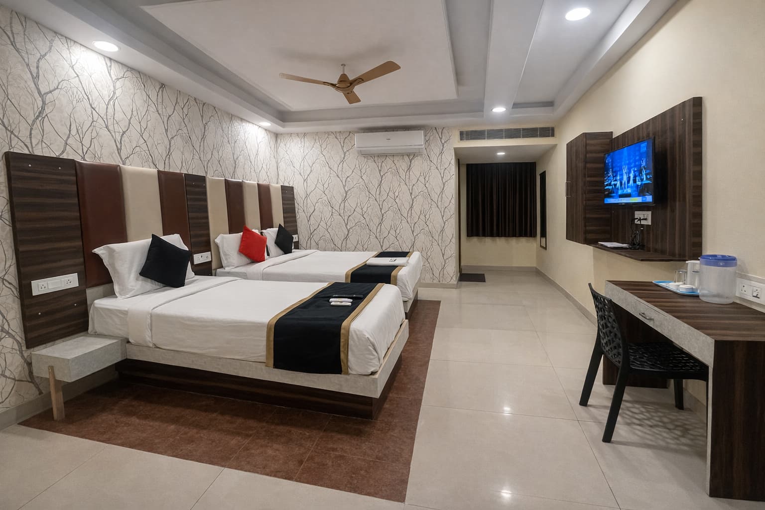 Triple occupancy AC room with twin beds and TV