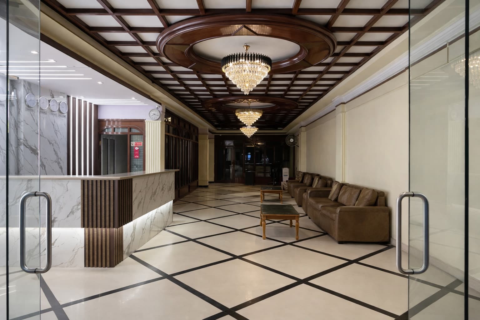 Grand lobby entrance of New Hotel Gateway Hyderabad with crystal chandeliers and marble interiors