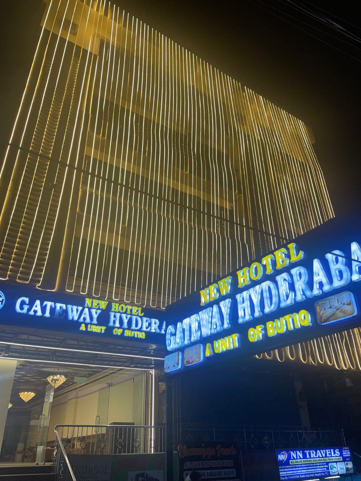 Hotel exterior with illuminated signage at night