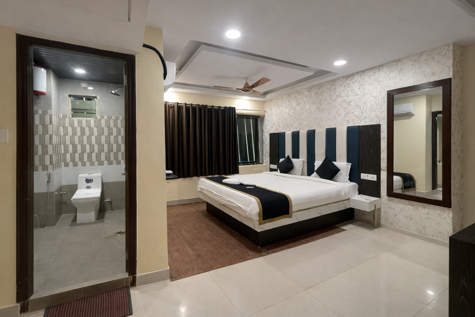 Room with attached bathroom and blue headboard