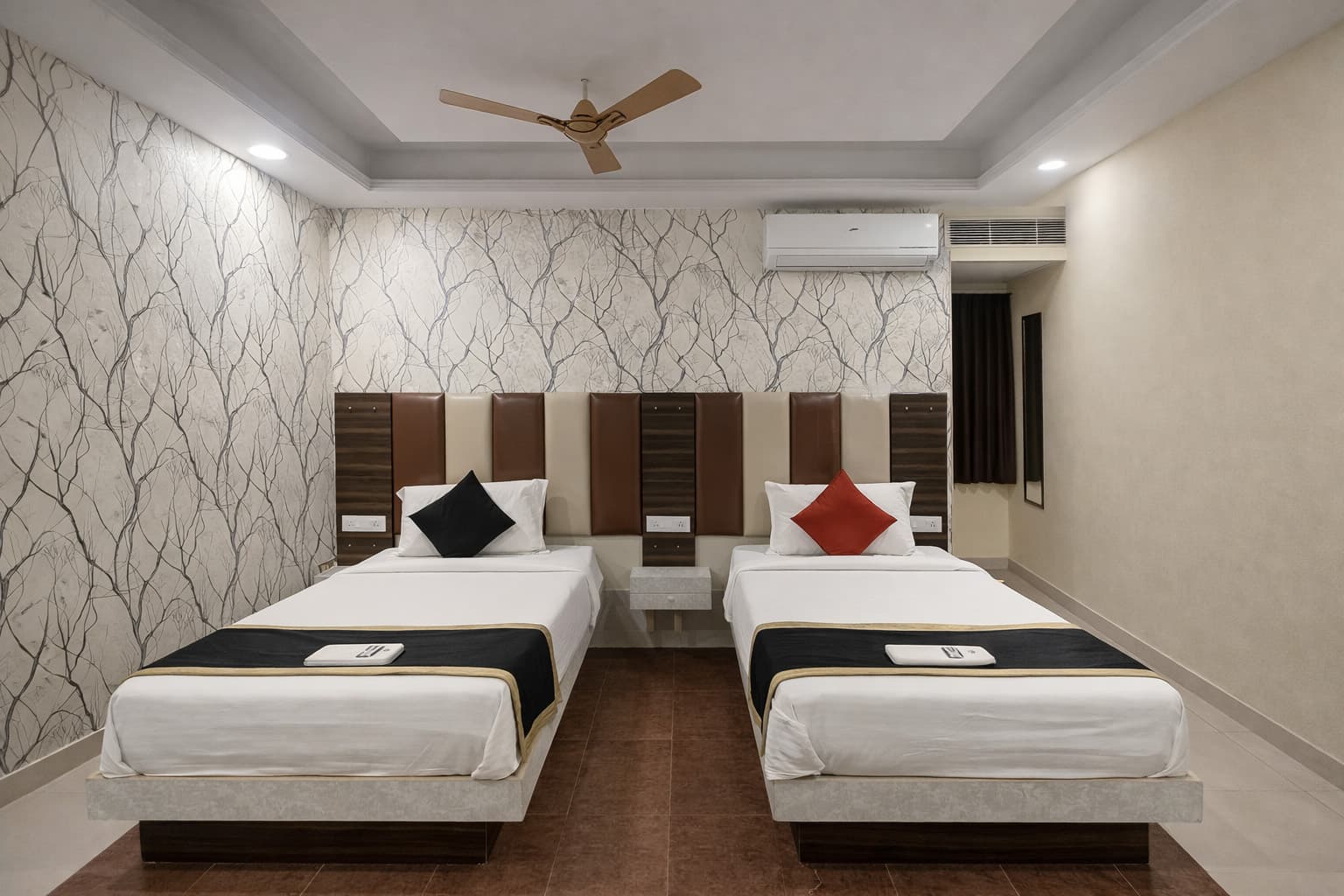 Twin bed room with patterned wallpaper and AC